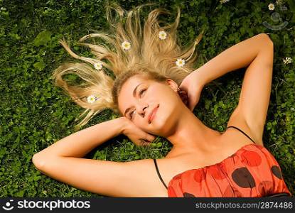 Young woman relaxing on a meadow