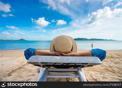 Young woman relaxing on beach, ocean view, Vacation Outdoors Seascape Concept