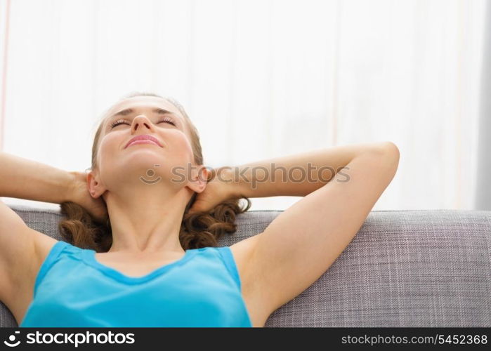 Young woman relaxing on couch in living room