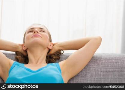 Young woman relaxing on couch in living room