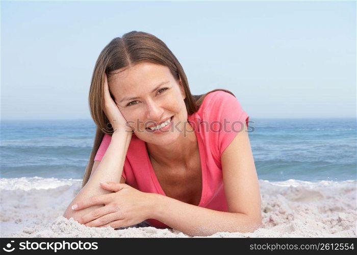 Young Woman Relaxing On Sandy Beach