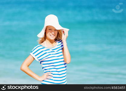 Young woman relaxing on the beach. Portrait of young pretty woman cheering and relaxing on sandy beach