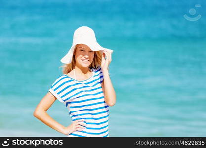 Young woman relaxing on the beach. Portrait of young pretty woman cheering and relaxing on sandy beach