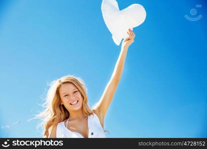 Young woman relaxing on the beach. Portrait of young pretty woman cheering and relaxing on sandy beach