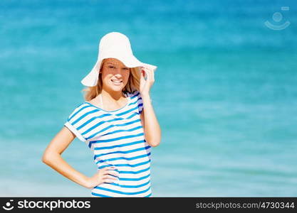 Young woman relaxing on the beach. Portrait of young pretty woman cheering and relaxing on sandy beach