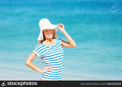 Young woman relaxing on the beach. Portrait of young pretty woman cheering and relaxing on sandy beach