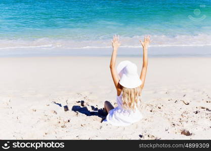 Young woman relaxing on the beach. Portrait of young pretty woman cheering and relaxing on sandy beach