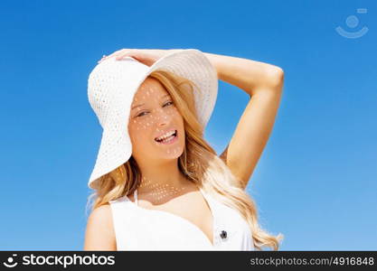 Young woman relaxing on the beach. Portrait of young pretty woman cheering and relaxing on sandy beach