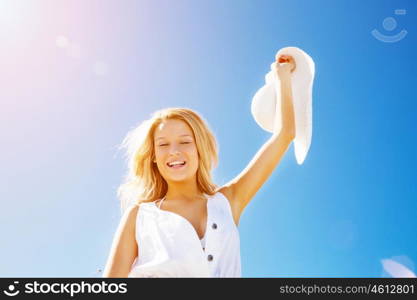 Young woman relaxing on the beach. Portrait of young pretty woman cheering on sandy beach