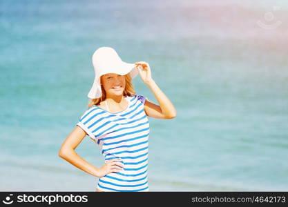 Young woman relaxing on the beach. Portrait of young pretty woman cheering on sandy beach