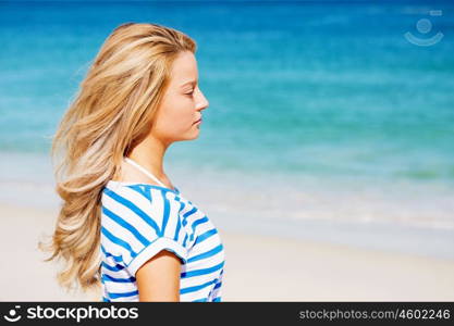 Young woman relaxing on the beach. Portrait of young pretty woman relaxing on sandy beach