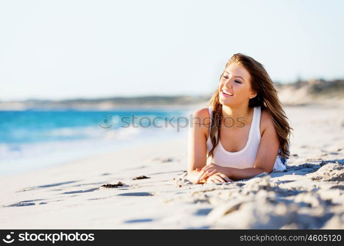 Young woman relaxing on the beach. Portrait of young pretty woman relaxing on sandy beach