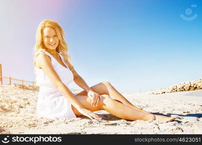 Young woman relaxing on the beach. Portrait of young pretty woman relaxing on sandy beach