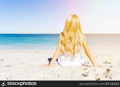 Young woman relaxing on the beach. Portrait of young pretty woman relaxing on sandy beach