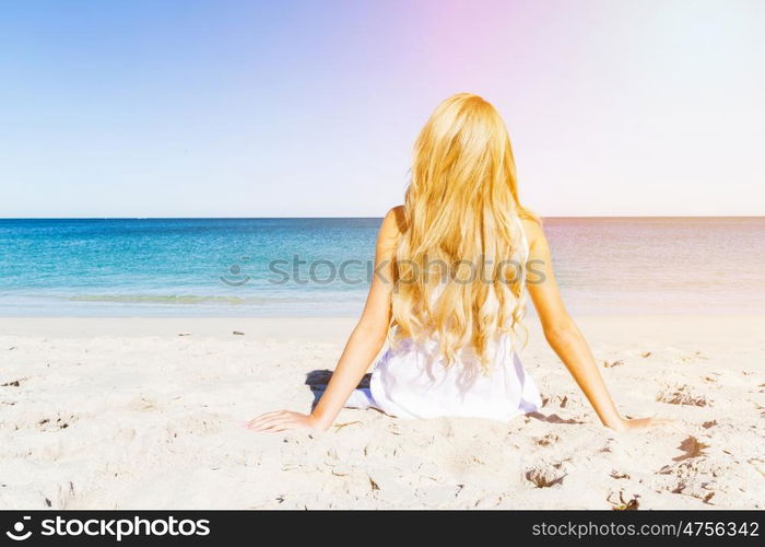 Young woman relaxing on the beach. Portrait of young pretty woman relaxing on sandy beach