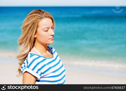 Young woman relaxing on the beach. Portrait of young pretty woman relaxing on sandy beach