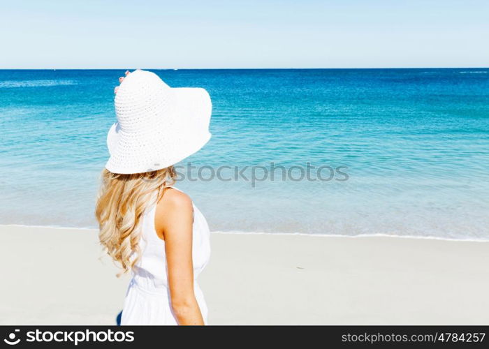 Young woman relaxing on the beach. Portrait of young pretty woman relaxing on sandy beach