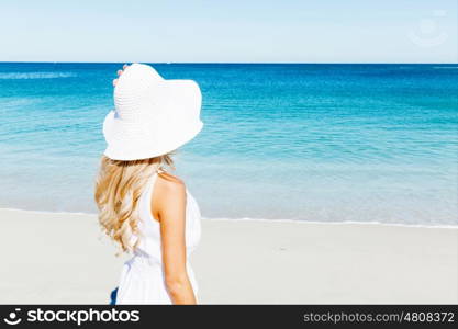 Young woman relaxing on the beach. Portrait of young pretty woman relaxing on sandy beach