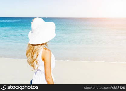 Young woman relaxing on the beach. Portrait of young pretty woman relaxing on sandy beach