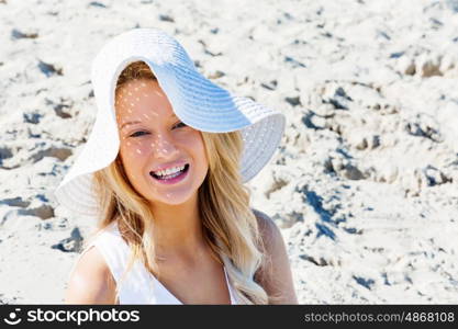 Young woman relaxing on the beach. Portrait of young pretty woman relaxing on sandy beach