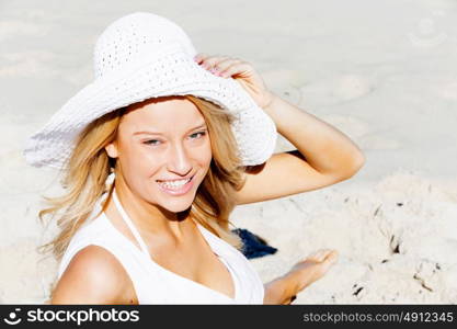 Young woman relaxing on the beach. Portrait of young pretty woman relaxing on sandy beach