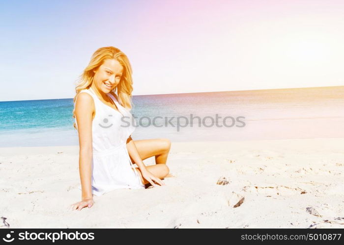 Young woman relaxing on the beach. Portrait of young pretty woman relaxing on sandy beach