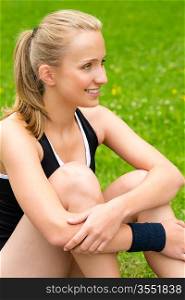 Young woman resting after workout on lawn happy smiling sport