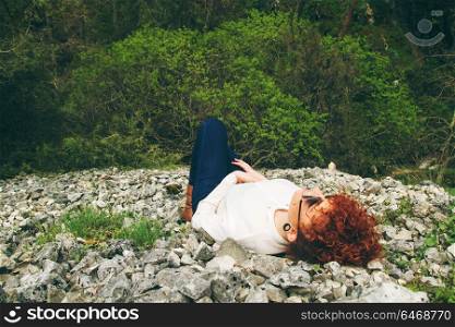 Young woman resting alone in the mountain