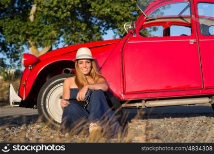 Young woman resting at car trip by the countryside