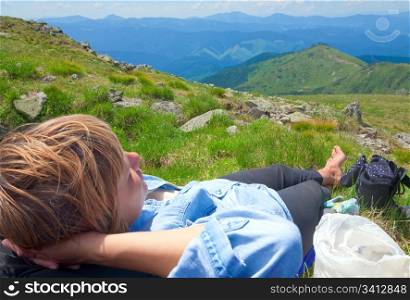 Young woman resting on a mountain top (Ukraine, Carpathian Mountains)