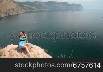 young woman Resting on the cliff near the Black Sea, Bay of Balaclava, Crimea