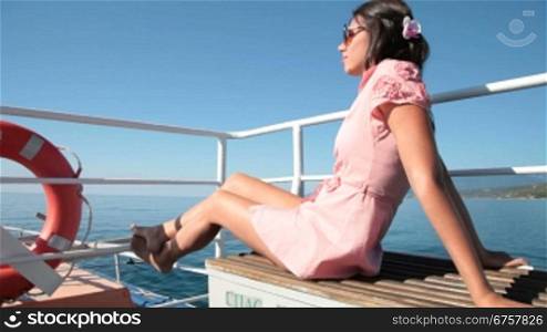 young woman resting on the deck of a passenger ship