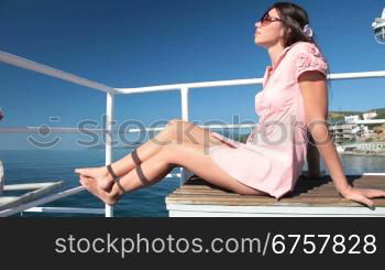 young woman resting on the deck of a passenger ship