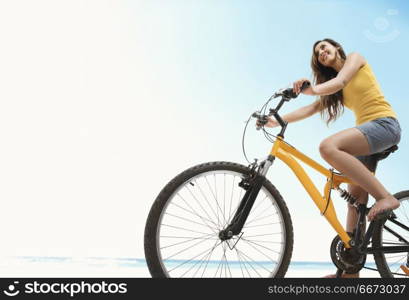 Young woman riding bicycle