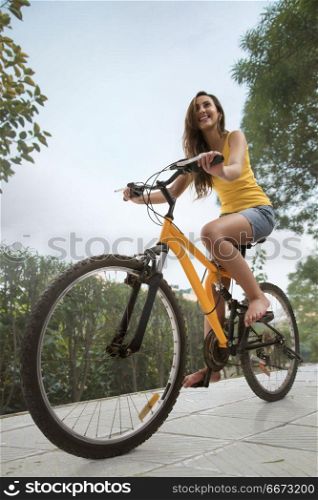 Young woman riding bicycle in park