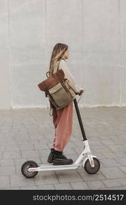 young woman riding electric scooter 24