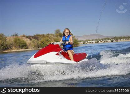 Young woman riding jetski on lake portrait