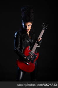 Young woman rock musician on black