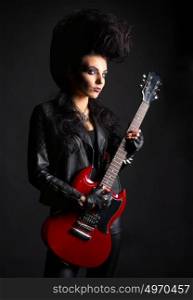 Young woman rock musician on black