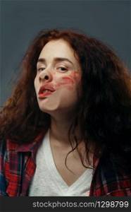 Young woman&rsquo;s face crushed on transparent glass, girl with smeared lipstick. Female person standing at the showcase with uncomfortable looking, humor, emotion expression. Woman&rsquo;s face crushed on glass, smeared lipstick