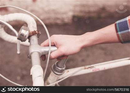 Young woman&rsquo;s hand holding the steer of a bicycle