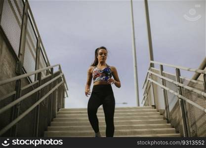 Young woman running alone down the stairs outdoor