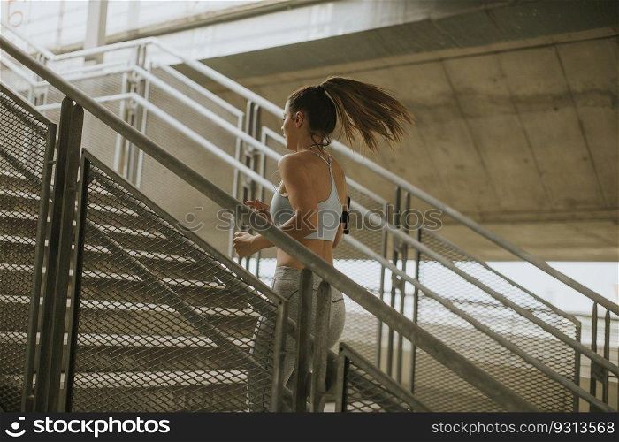 Young woman running alone up stairs  outdoor