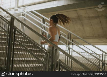 Young woman running alone up stairs  outdoor