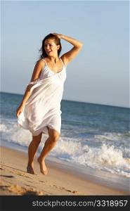 Young Woman Running Along Summer Beach