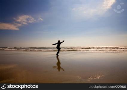 young woman running at the wet beach