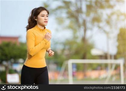 young woman running in the park in early morning