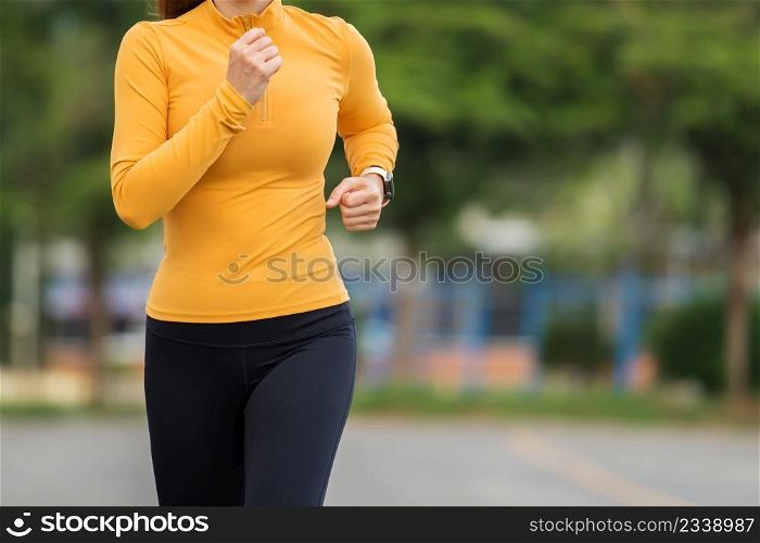 young woman running in the park in early morning