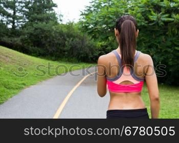 Young woman running on the jogging trail