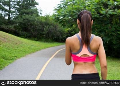 Young woman running on the jogging trail